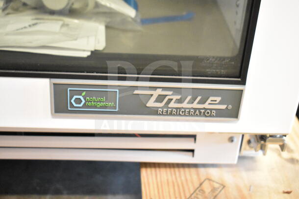 True TSCI-150PR-SWG-R-WW-1A commercial mini cooler merchandiser with "natural refrigerant" label shown.
