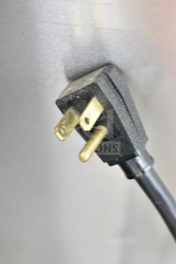 Close-up of a plug from a 2016 True T-35 commercial cooler. 115 volts, 1 phase. Plug features three prongs.