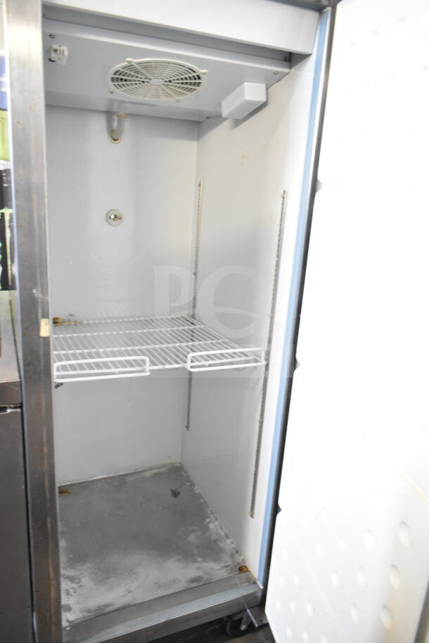 Central 69K-034 Commercial Single Door Reach In Freezer, 115V, 1 Phase. Interior with wire shelf, fan unit, used condition.