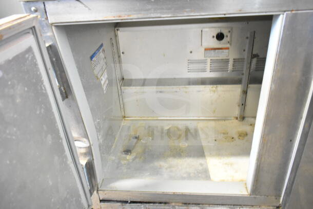Beverage Air UCT48A 2-door undercounter cooler, interior view. Shows wear and visible labels. 115 volts, 1 phase.