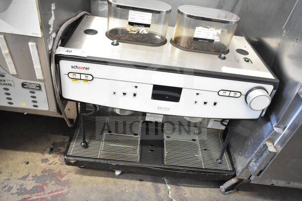 Schaerer Barista commercial espresso machine with 2 groups, 2 hoppers, and 2 steam wands, in used condition.