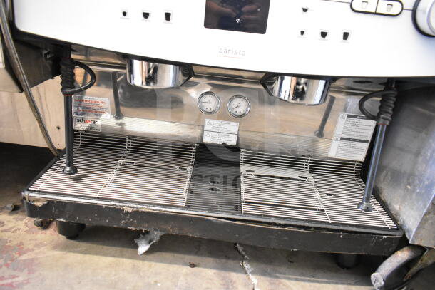 Schaerer Barista commercial espresso machine with 2 groups, 2 hoppers, and 2 steam wands. Includes gauges and warning labels.