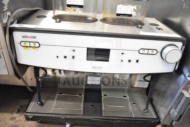 Schaerer Barista 2 Group Espresso Machine, equipped with 2 hoppers and steam wands. Functional buttons and dials visible.