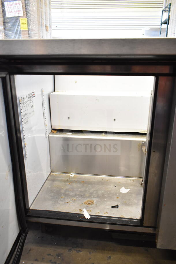 True TSSU-48-18M-B commercial prep table, missing lid, visible interior shelving, 115 volts, 1 phase, used condition.