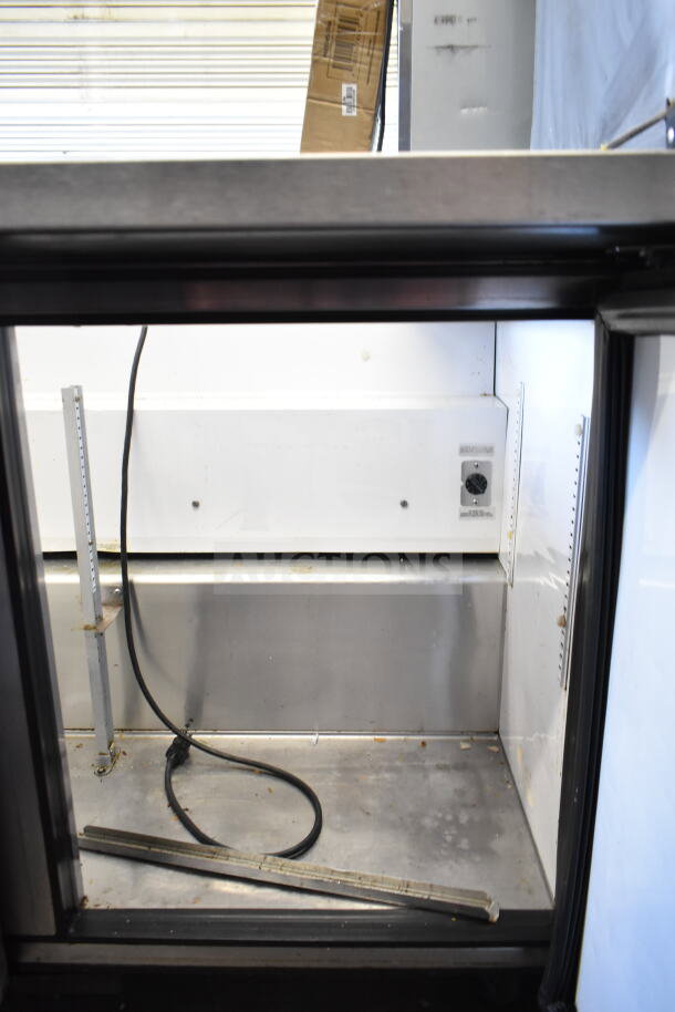 True TSSU-48-18M-B commercial prep table interior view, missing lid, 115 volts, 1 phase, showing stainless steel construction.