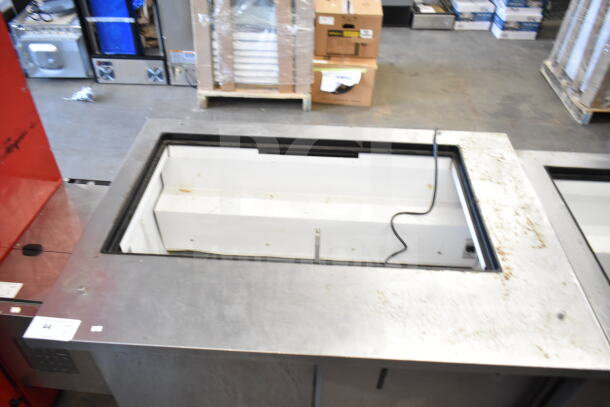 True TSSU-48-18M-B commercial prep table, missing lid, 115 volts, 1 phase, stainless steel surface, visible wear.