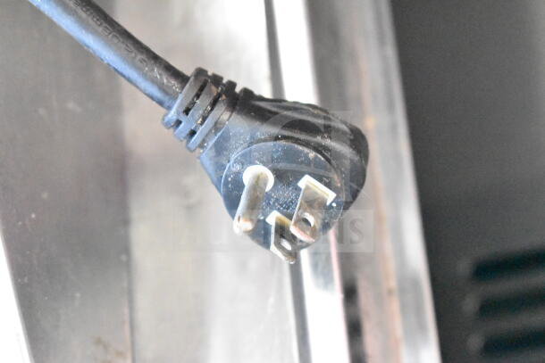 Power cord of Turbo Air TST-72SD-30-N prep table. Features 115 volts, 1 phase. In good condition, minor wear visible.