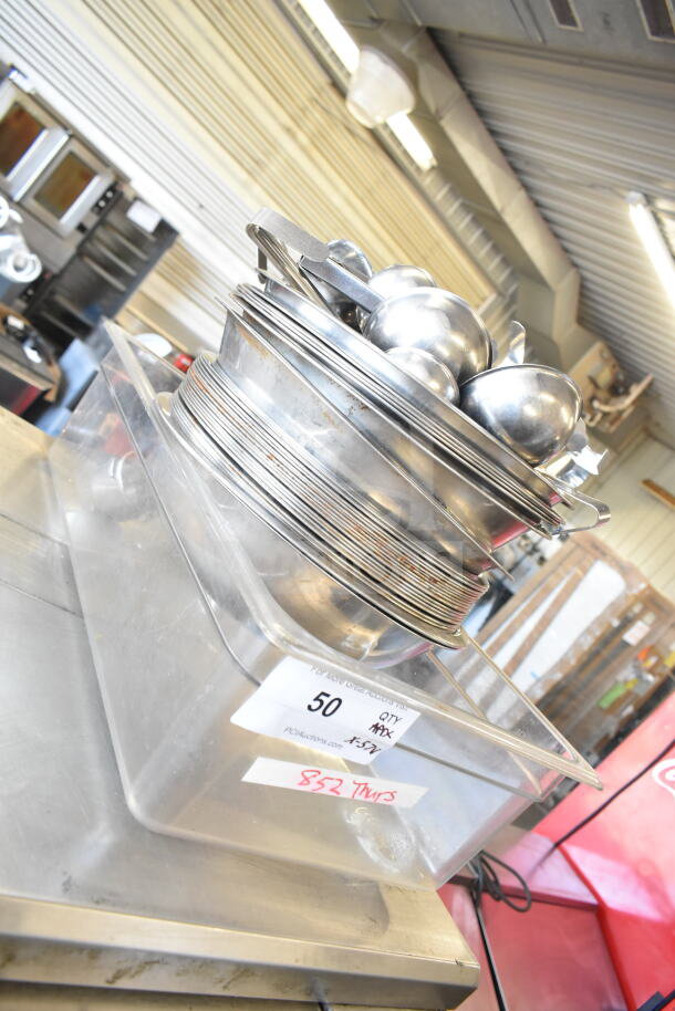 57 various kitchen items including metal ladles, bowls, and a poly drop-in bin. Auction lot labeled "57 Times Your Bid."