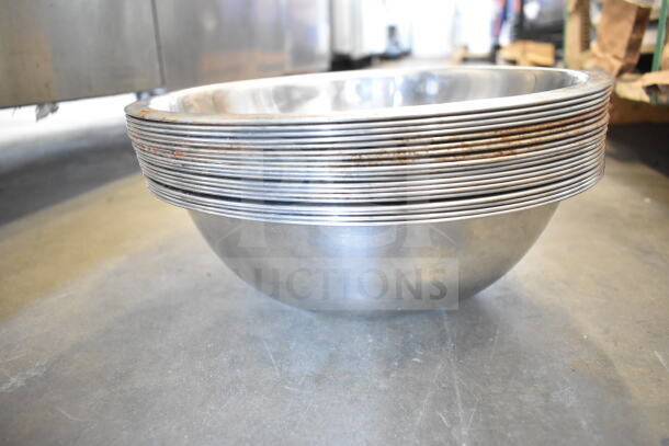 Stack of stainless steel bowls, slight rust on rims, part of 57 item auction lot including ladles and poly bin.