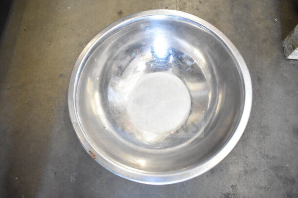 Metal bowl with reflective surface and visible wear, part of 57 various kitchen items lot. Perfect for multipurpose use.