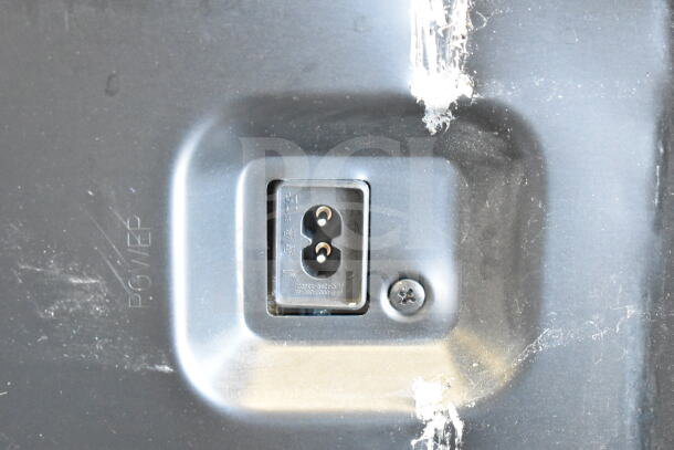 Close-up of a power input socket on a television, marked "POWER," showing some wear.