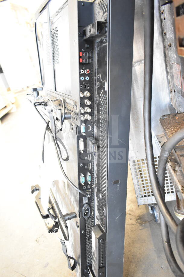 Back panel of three televisions, including Samsung UN50EH5300F and NEC MultiSync P402, showing ports and cables.