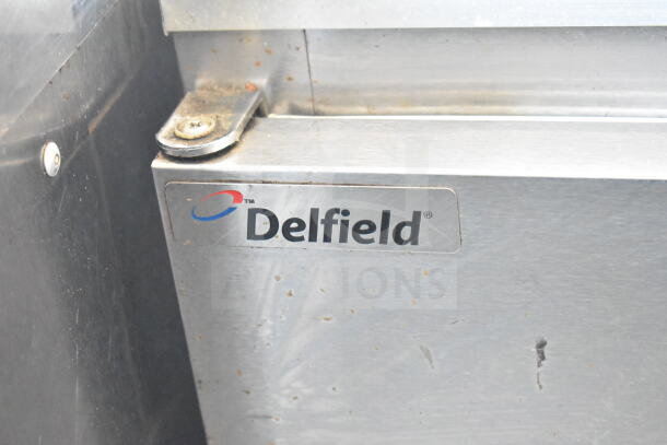 Delfield 406CA-DHL-DD1 stainless steel undercounter cooler, single door, visible Delfield logo, slight surface wear.