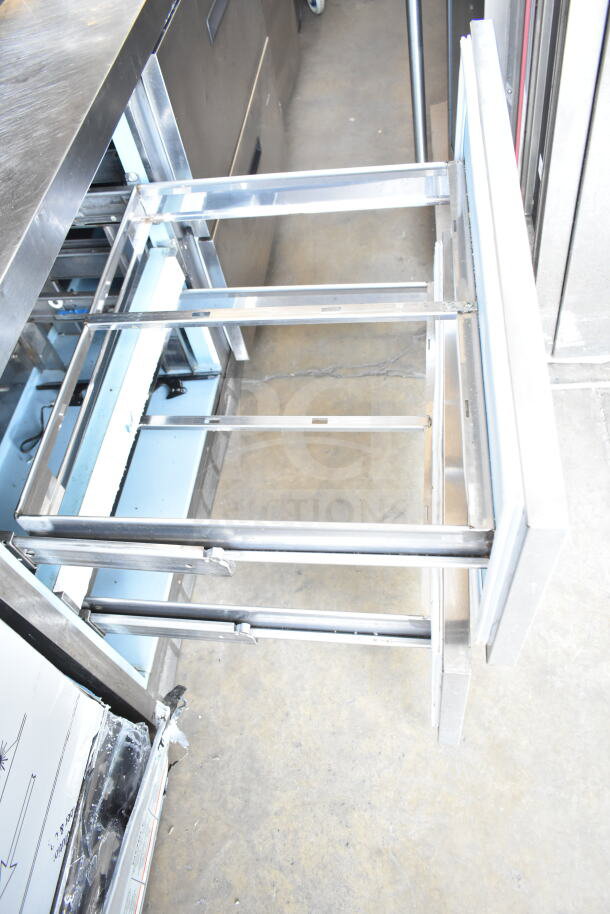 Delfield commercial sandwich salad prep table, mega top with 4 drawers and overshelf, 115 volts, 1 phase, open drawer view.