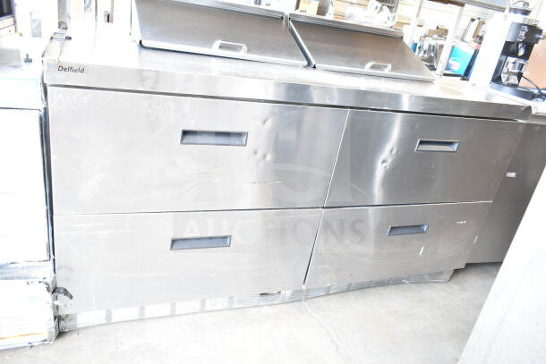 Delfield commercial sandwich salad prep table, 4 drawers, over shelf, 115V, visible brand logo, minor wear on surface.