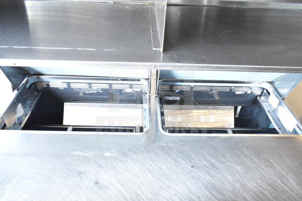 Delfield commercial prep table, mega top with 4 drawers, and over shelf. Stainless steel, 115V, 1 phase, used condition.