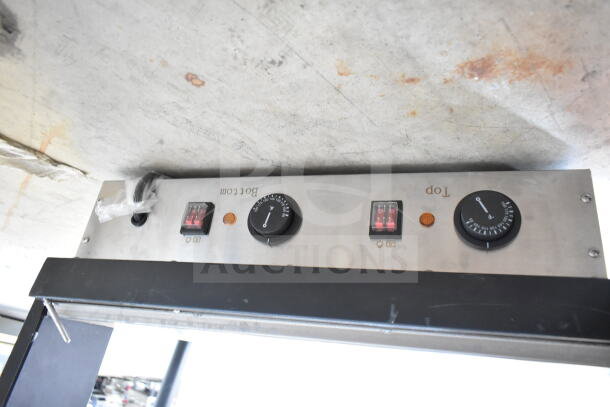 Control panel of the ServIt 423OAM65D 24" heated display merchandiser, showing dials and switches for temperature control.