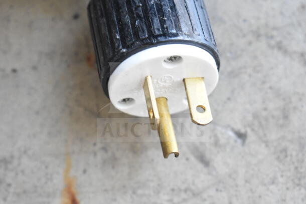 Close-up of a three-pronged plug for the ServIt 423OAM65D 24" countertop heated display merchandiser.