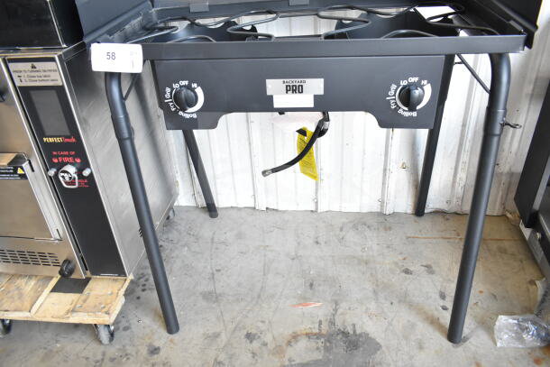 Brand new Backyard Pro double burner outdoor range with side shelves, 110,000 BTU, minor scratches and dents, labeled controls.