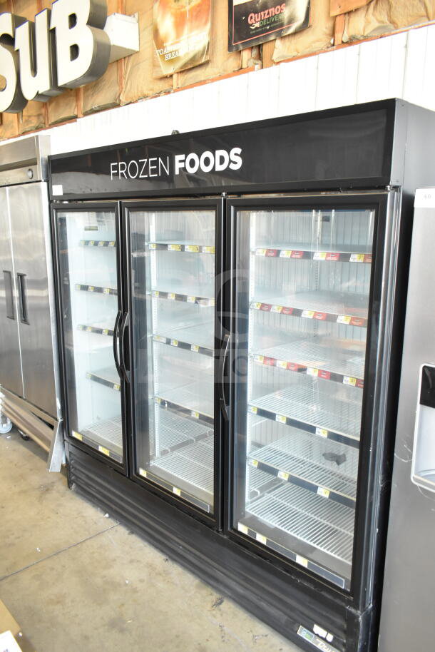 2017 True GDM-72F-HC commercial freezer, 3 glass doors, black exterior, clean interior shelves, 115/208-230V, 1 Phase.