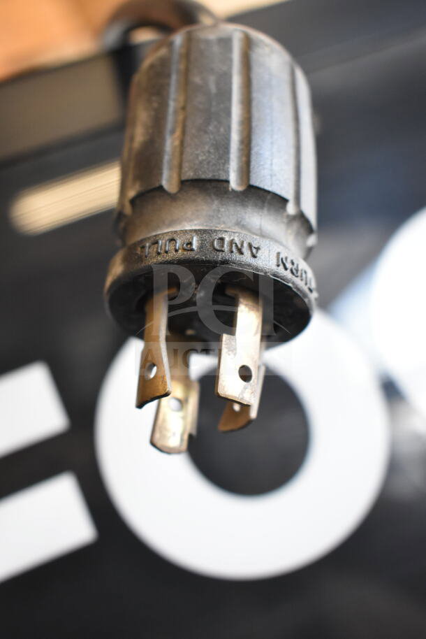 Close-up of the 2017 True GDM-72F-HC freezer plug, showing prong details and "TURN AND PULL" marking, indicating power type.