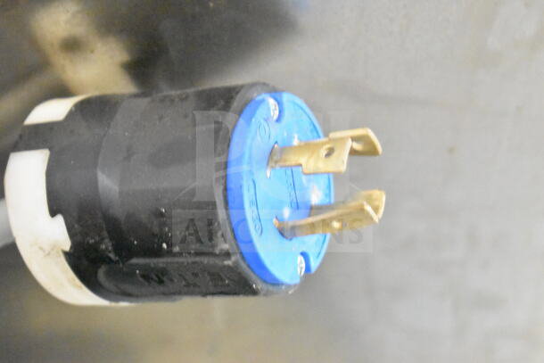 Close-up of a power plug for a Desmon GBF-15+ETL commercial blast chiller. Black and blue casing, brass prongs.