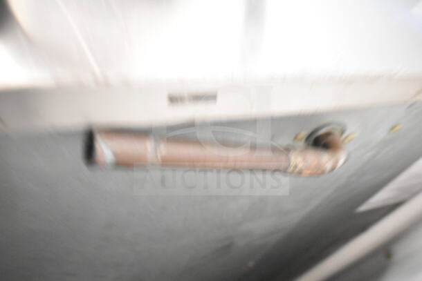 Blurry image of Hoshizaki KM-900MRH ice machine part, copper piping visible. Condition unclear. 208-230V, 1 phase.