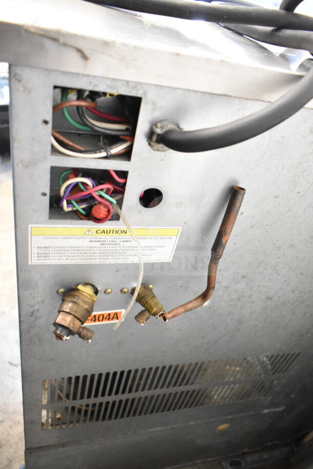 Hoshizaki KM-900MRH commercial ice machine head, 208-230V, 1 Phase, visible wiring, caution label, and R404A mark.