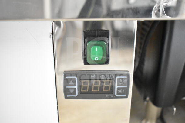 "Control panel of KoolMore CDA-13C Merchandiser, featuring green toggle switch and digital display for temperature settings."