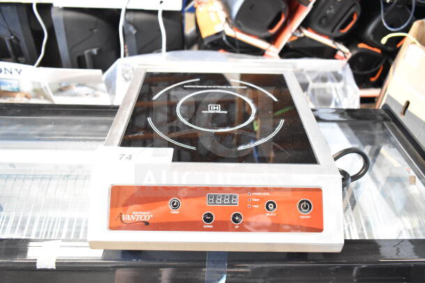 Brand new Avantco 177IC3500 countertop induction range, visible controls and power indicators, slight scratches.