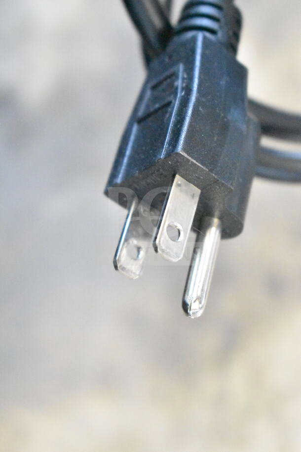 Close-up of a standard three-prong power plug, likely part of the Avantco display case mentioned.