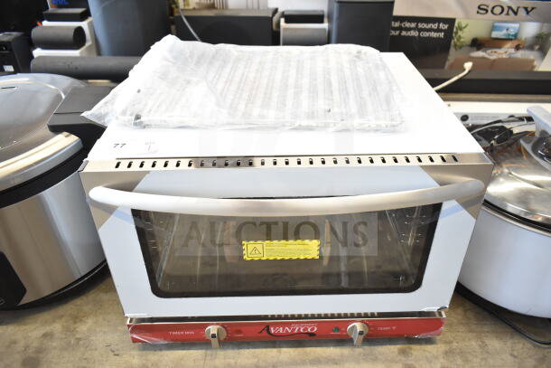 Brand new Avantco 177CO16 half-size countertop convection oven, 1.5 Cu. Ft., 120V, minor scratches, includes manual and sheet pan.