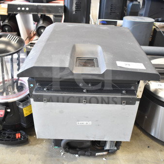 Auction item: Mini Cooler. Black top with metallic body, handles visible. Label indicates model number. Slight wear evident.