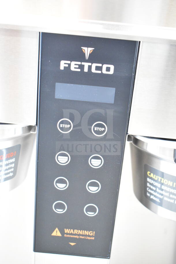 Fetco CBS-1242 Coffee Brewer, digital controls, dual brewers, warning labels visible, good condition, 208-240V, 1 phase.