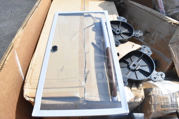 16 brand new scratch and dent items, including a glass panel with handle and multiple table leg pieces, all in boxes.