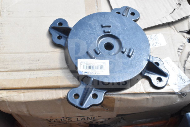 Black table leg piece with mounting holes, brand new condition, barcode label visible, on a cardboard box.