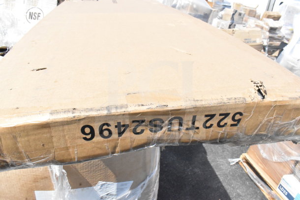 Cardboard box labeled "5224TU52496" with minor scratches and dents; part of auction lot including mop sink and mop heads.