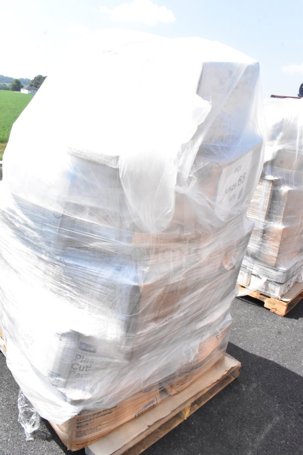 Shrink-wrapped pallet with assorted scratch and dent items, including barrels, cups, plates, and bakery boxes. Visible "JUN26-65" label.
