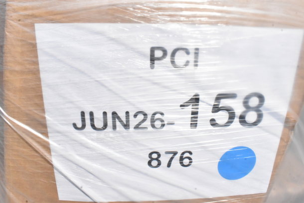 Alt text: Auction label on wrapped box, marked "PCI JUN26-158 876" with a blue dot, indicating a scratch and dent lot.