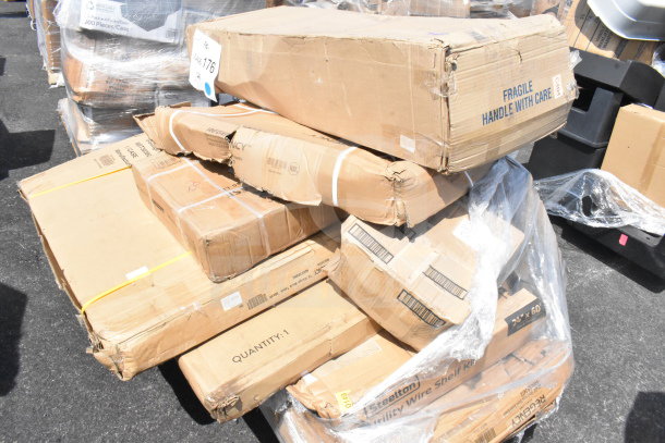 Boxes labeled "Regency" and "Stelton" in a pallet with signs of damage. Items include scratch and dent stock.