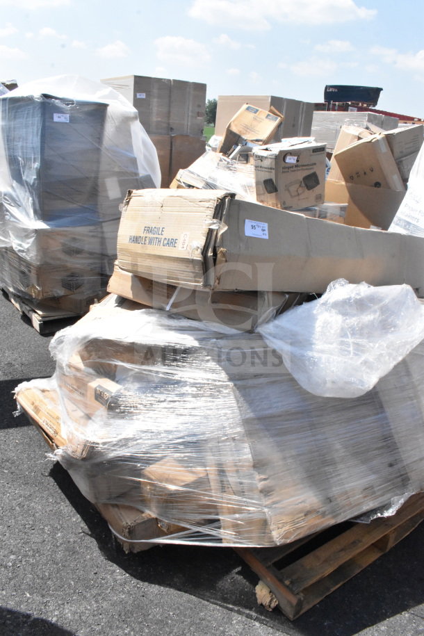 Plastic-wrapped pallet of 12 new scratch and dent items, including Bobrick paper towel dispenser, easel, stock pot, with visible fragile labels.