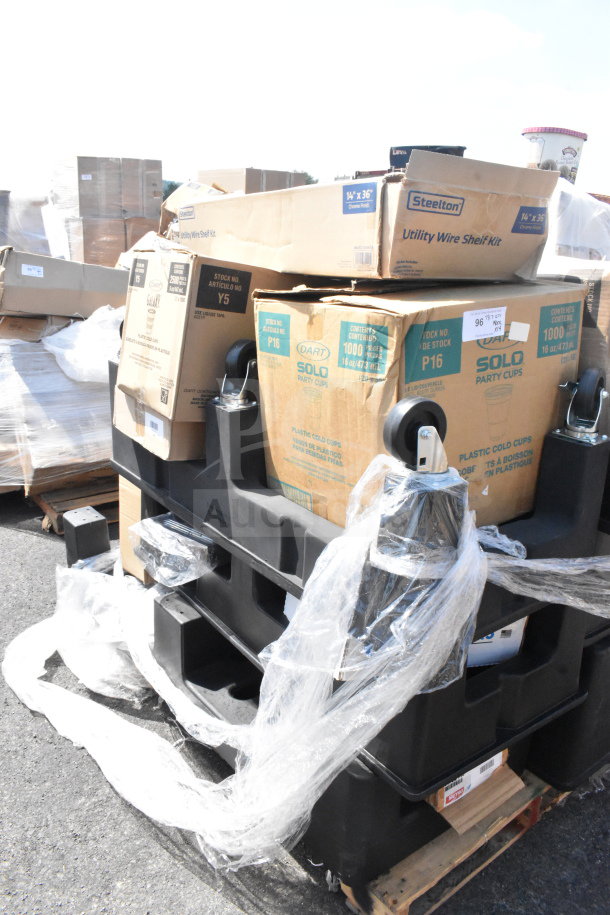 Alt text: Stack of black poly dunnage racks with boxes labeled "Steelton Utility Wire Shelf Kit" and "Solo Party Cups," on pallet.