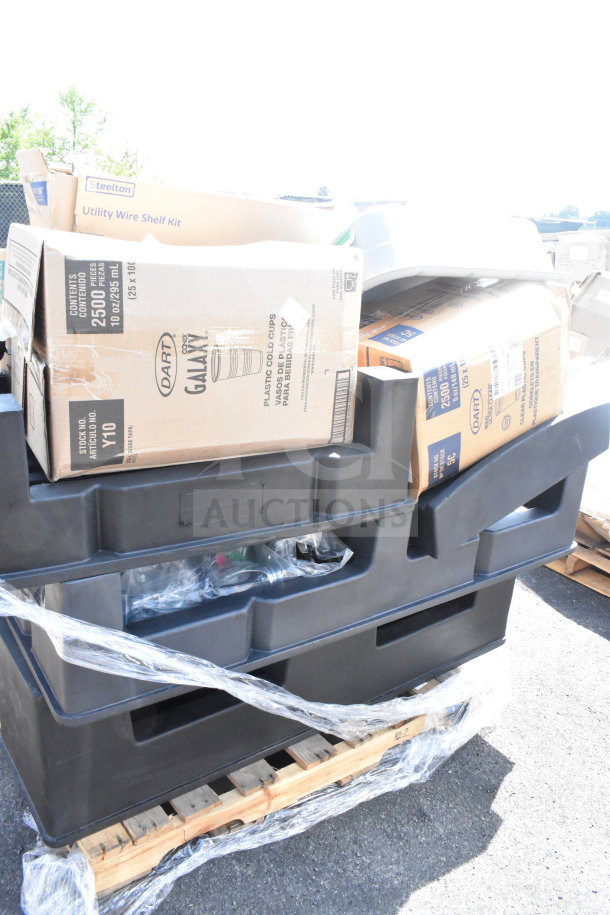 14 new scratch and dent items on pallet, featuring black poly dunnage racks and assorted boxes.