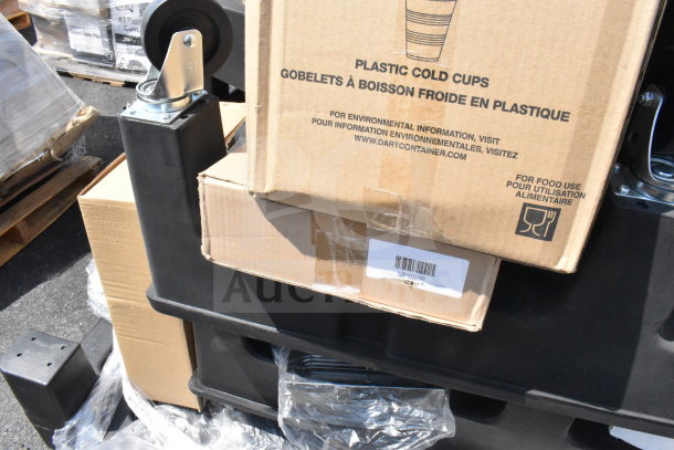 14 new black poly dunnage racks with visible cardboard boxes. Scratch and dent condition. Includes wheel attachments.