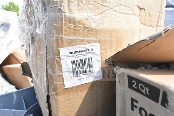 Cardboard box labeled "382PM8KETTLE," containing a popcorn machine replacement kettle. Box shows signs of wear.