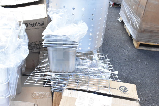 18 new scratch and dent items, including tumblers, drainboard, and lids, shown on a wire rack and cardboard box.