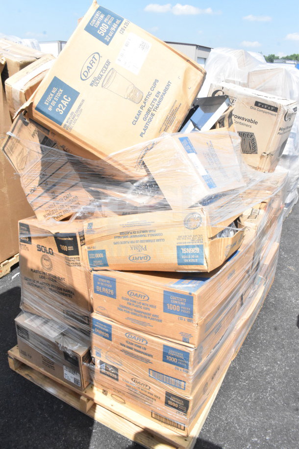 Pallet of mixed brand new scratch and dent items, including Dart plastic cups, Solo lids, and other packaged goods.