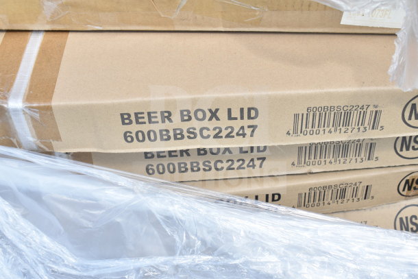 Cardboard boxes labeled "Beer Box Lid 600BBSC2247" stacked and wrapped in plastic, part of a scratch and dent auction lot.