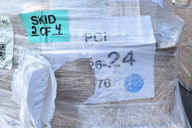 Pallet of 26 new scratch and dent items, including glasses, bowls, food trays, wrapped in plastic, with labels and SKU visible.