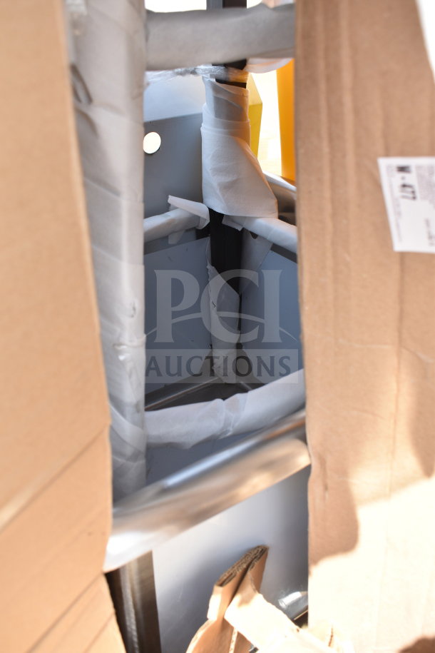 13 new scratch and dent items, including a trash can and wall shelf. Items partly wrapped, cardboard packaging visible.